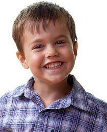 photo of a smiling young boy in a flannel shirt - no emergencies for him today!