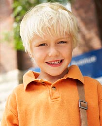 photo of a smiling young boy with healthy teeth and a cute smile